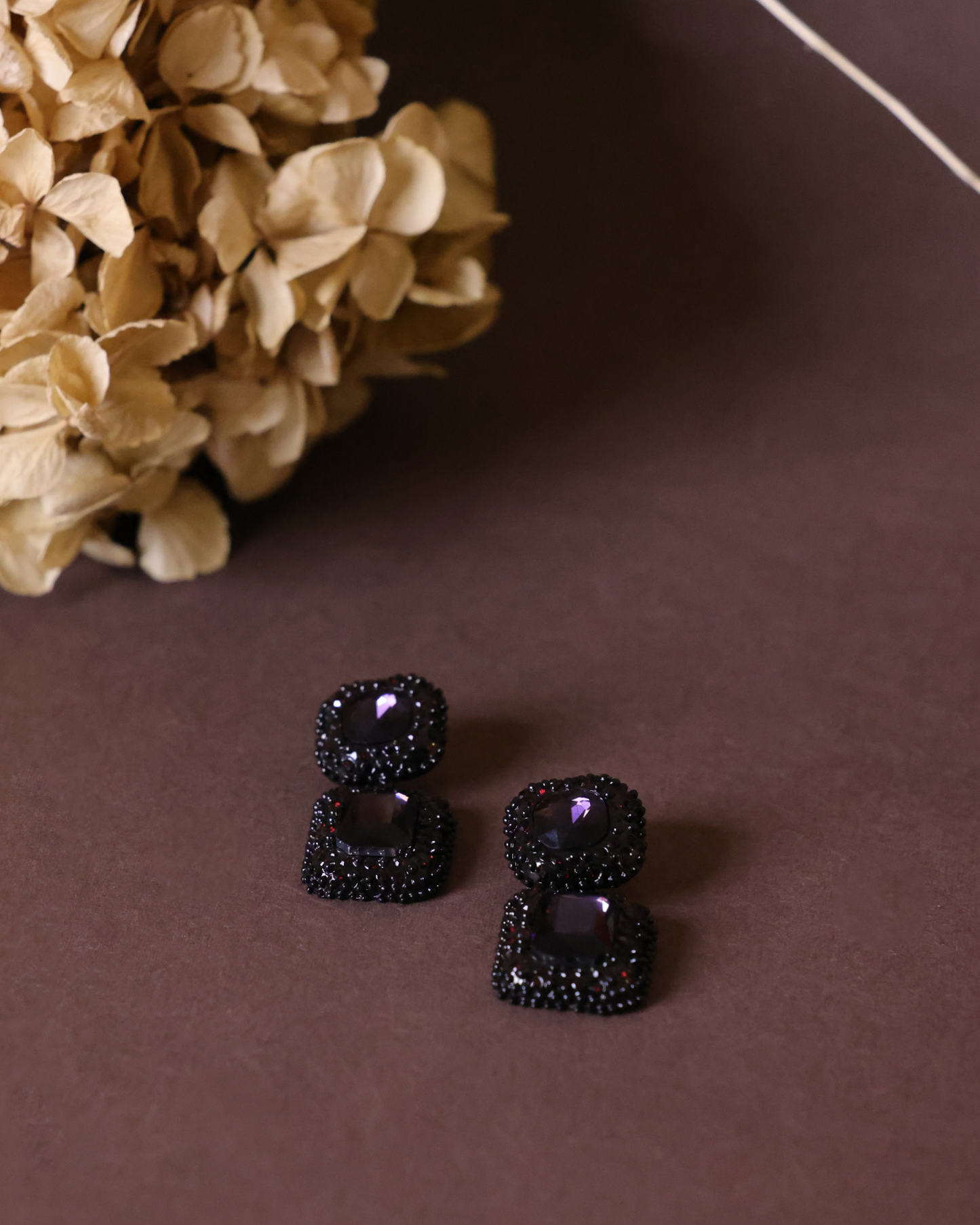 Black and purple dangler earrings