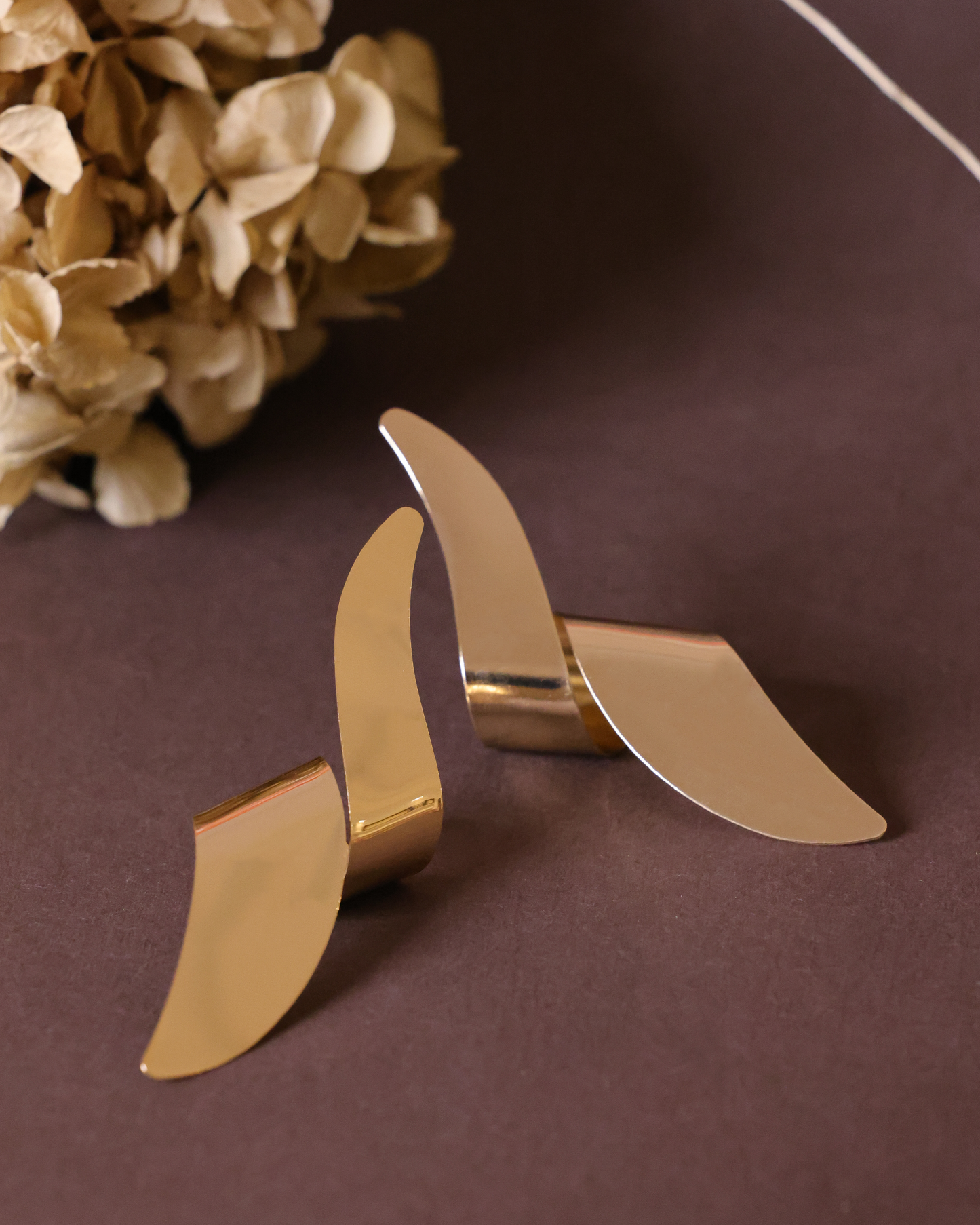 Gold long twisted earrings