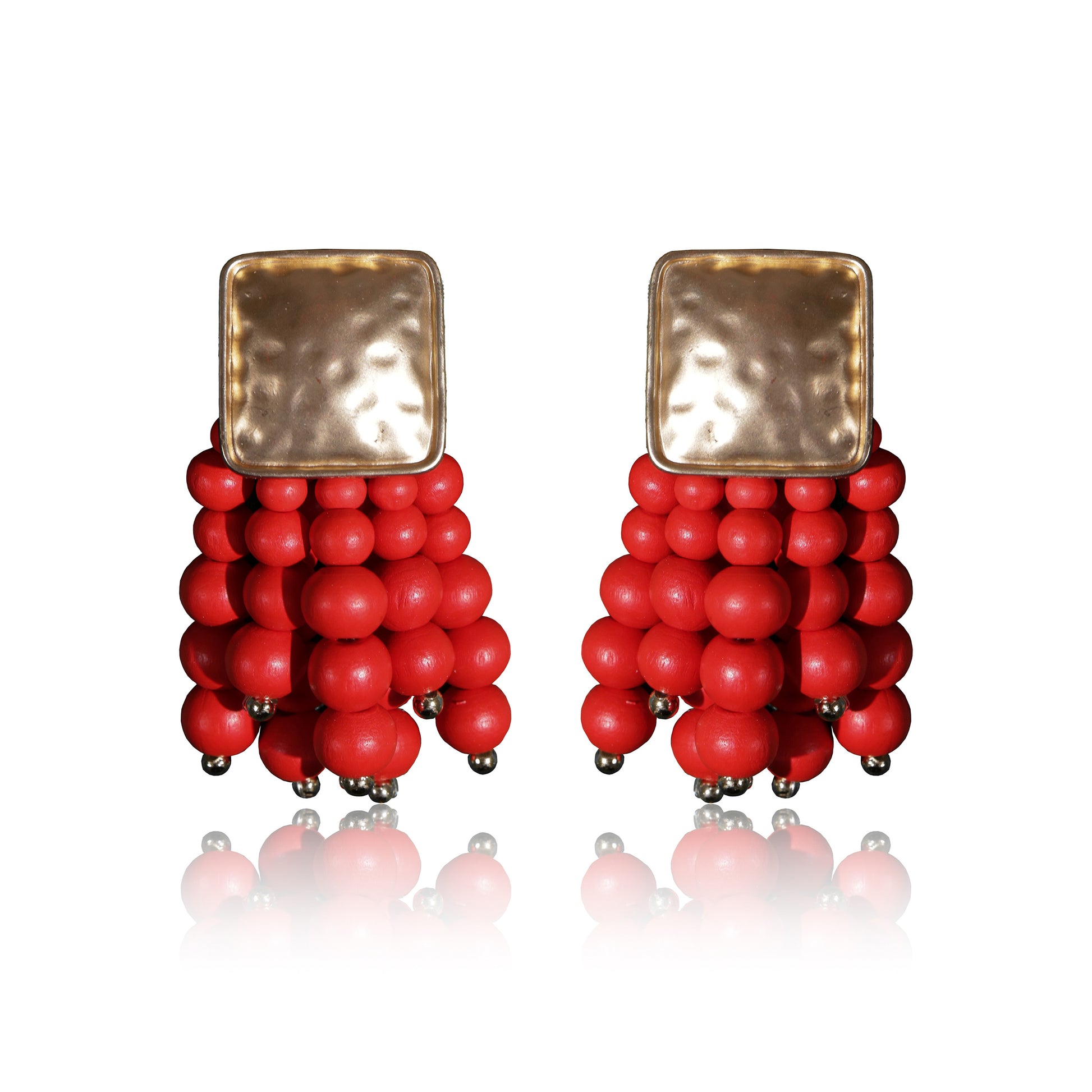 Beady Red and Gold Earrings feature hammered gold-plated square tops and clusters of shiny red beads—perfect summer jewelry to add a touch of luxury to any outfit. Displayed on white with a reflected shadow.
