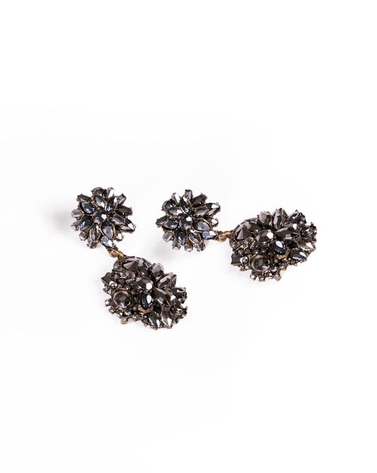 Black Magic Earrings: Vintage-style 24K gold-plated earrings featuring dark, faceted gemstones in floral clusters set on a metallic base, displayed against a white background.
