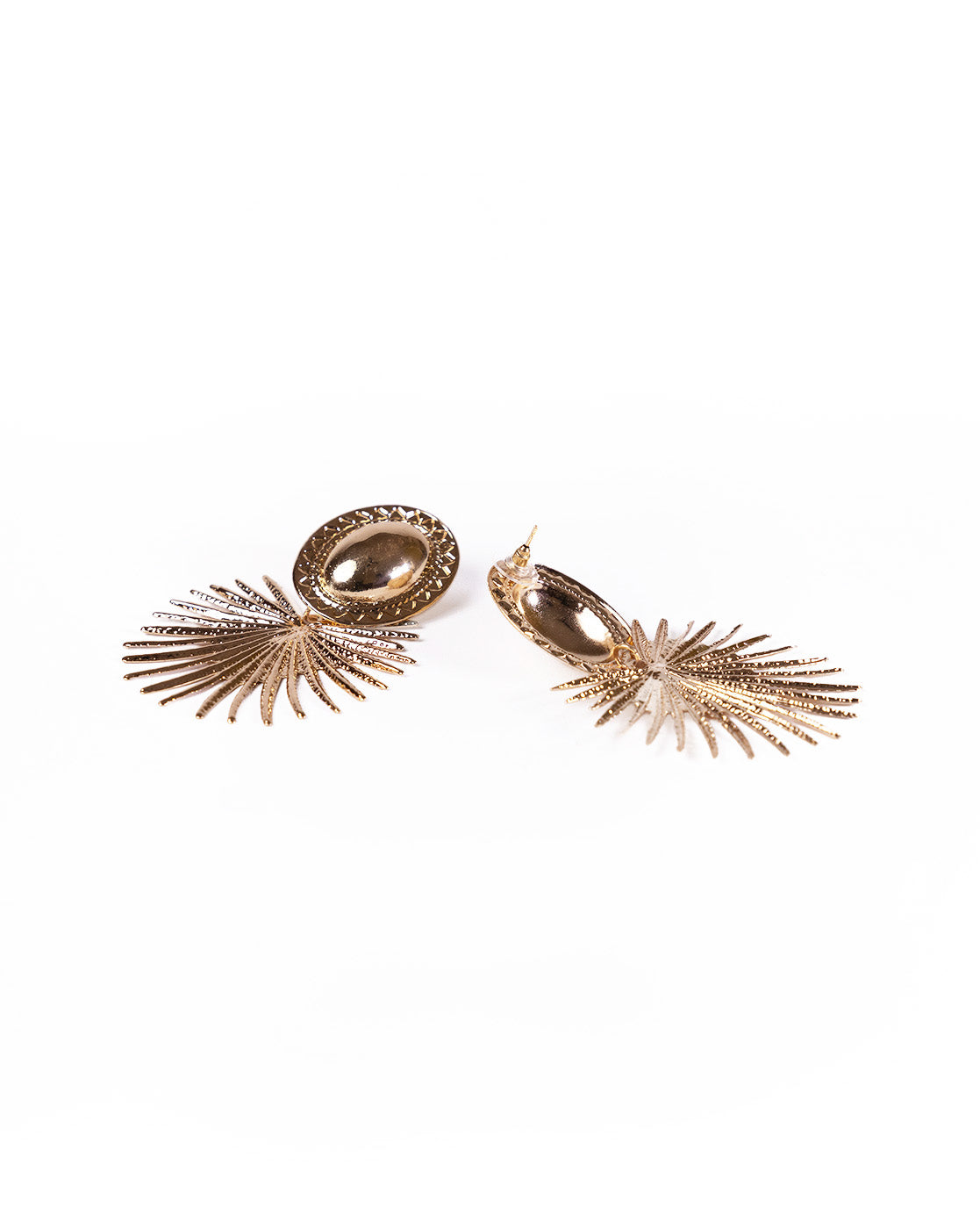The Sun Rays Earrings are 18K gold statement pieces featuring oval studs and intricate, fan-shaped designs reminiscent of stylized palm leaves, shown against a white background.