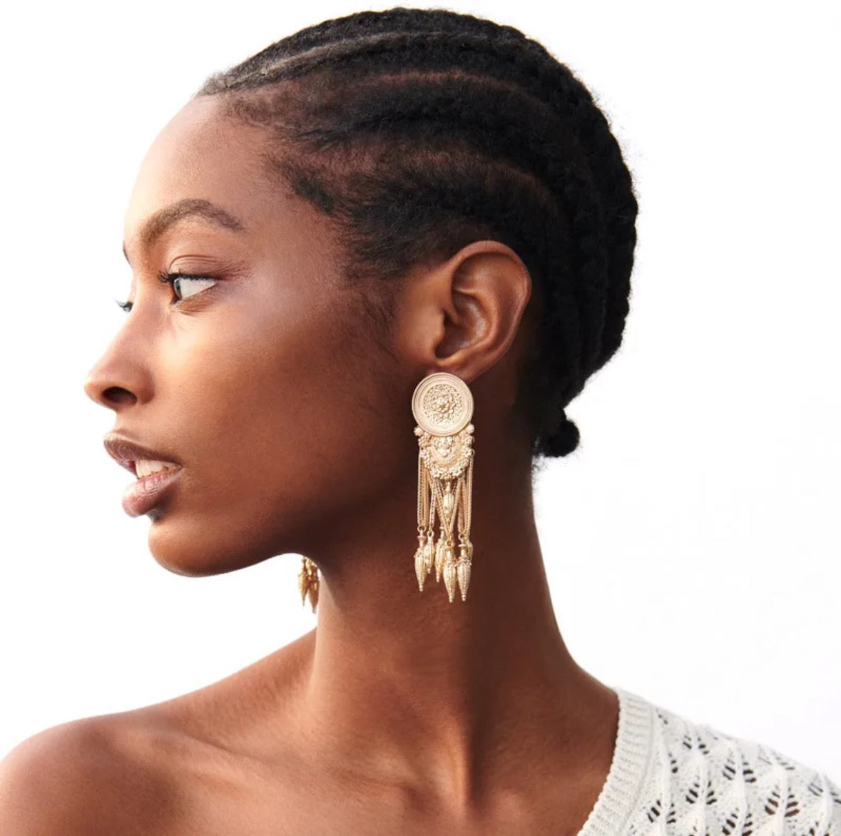 girl wearing gold tassels earrings