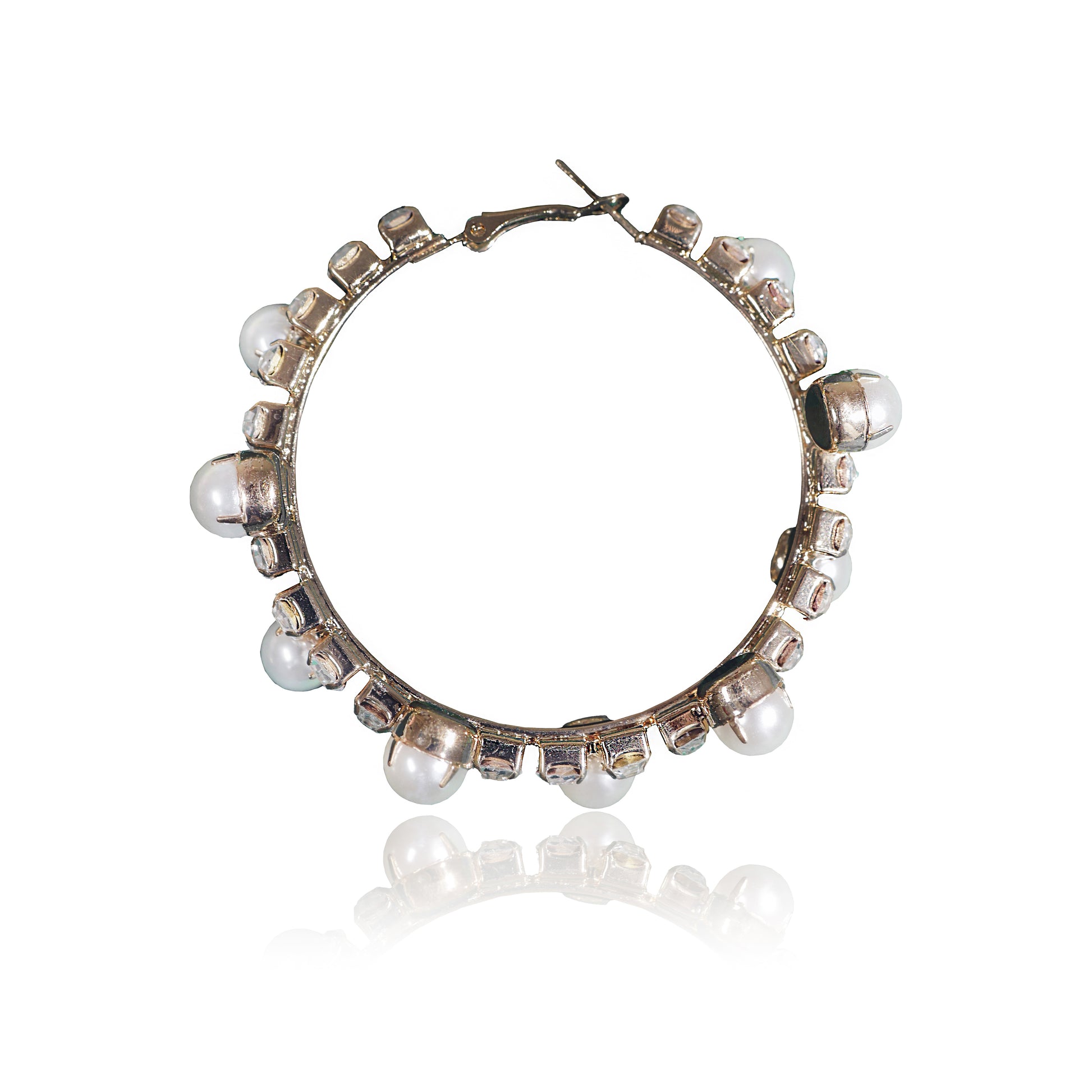 The Gold Pearl and Crystal Hoops are gold-plated hoop earrings featuring evenly spaced white pearls and small square crystal accents, displayed on a white background with a subtle reflection below.